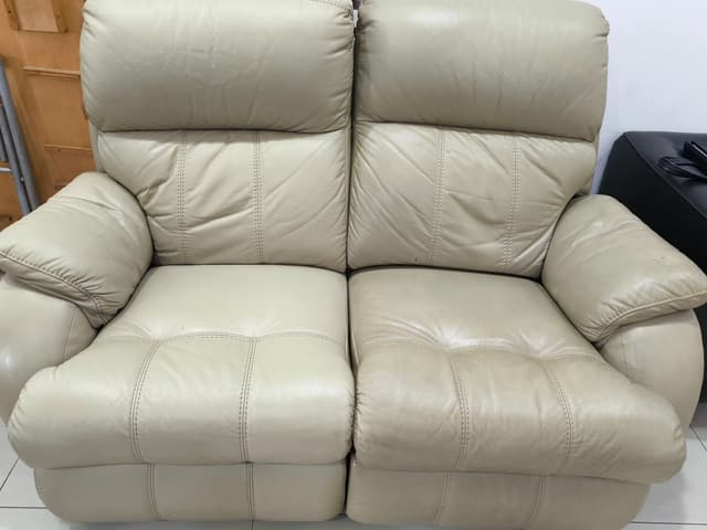 Beige leather two-seater sofa