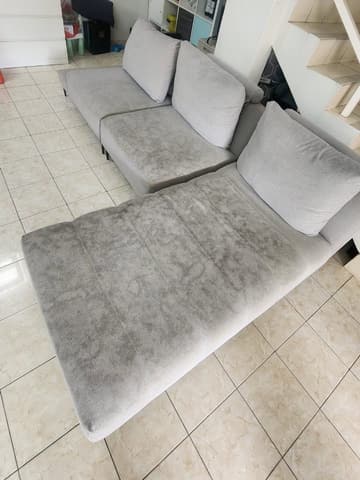 L-shaped sofa by the staircase, before cleaning